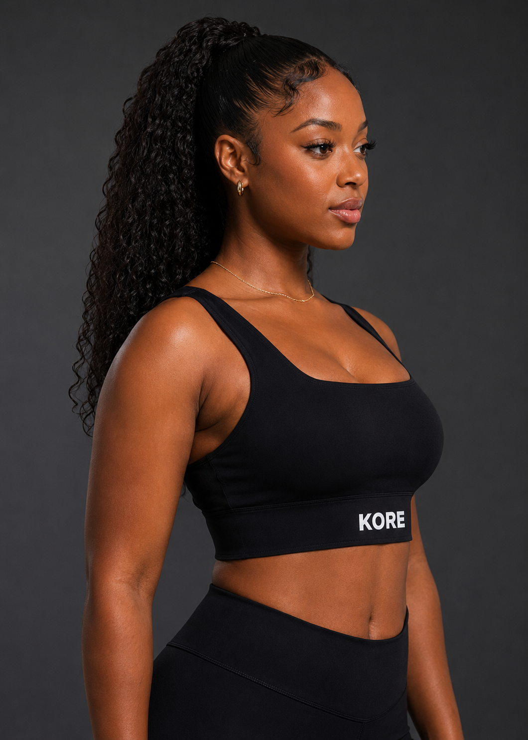 KORE Sculpt Bra — side profile showing sculpted fit, sharp fabric texture, and front underband logo detail