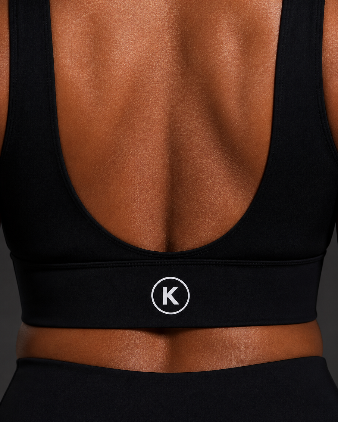 KORE Sculpt Bra — open-back view with crisp centered K. icon on the underband