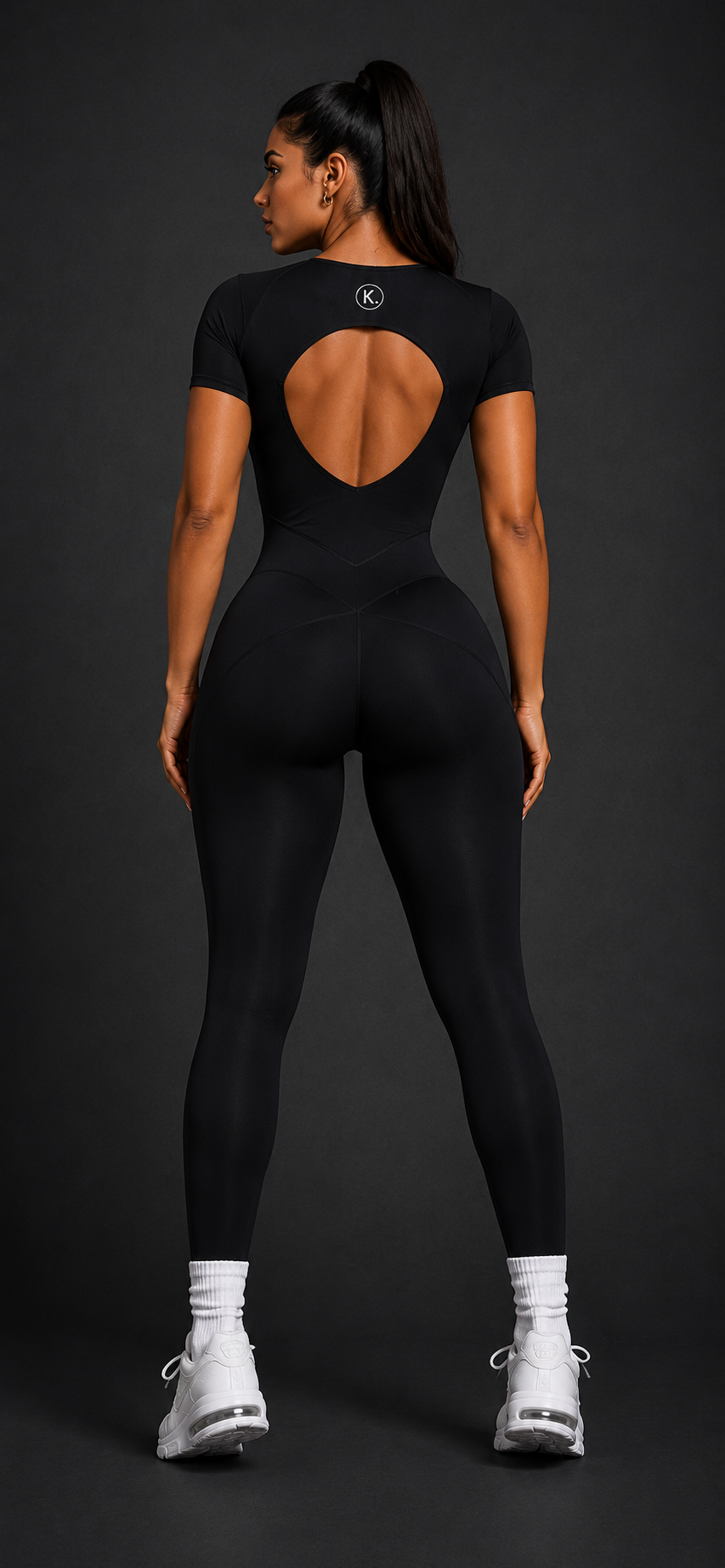 KORE Sculpt Bodysuit — full back view showing the open-back cutout, contour seamwork, and full-length silhouette