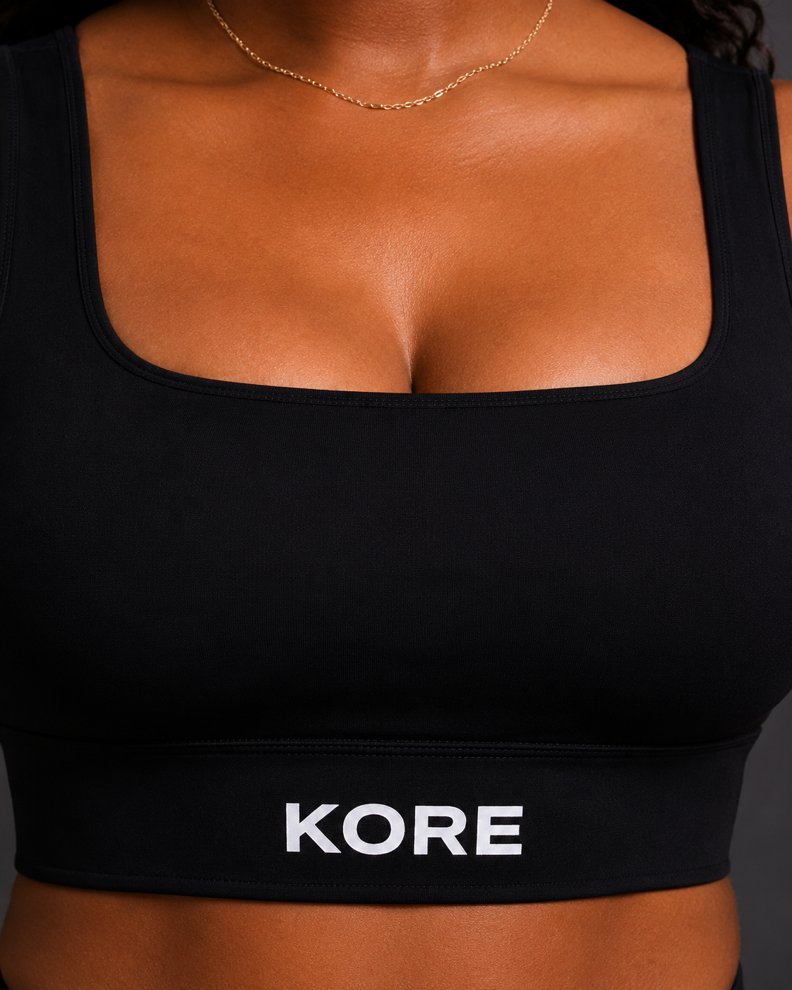 KORE Sculpt Bra — close-up of the front underband with sharp centered KORE logo and visible stitching detail